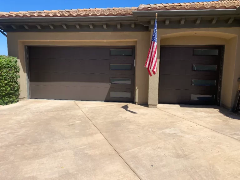 Pair of modern dark garage doors with window inserts, a PLL project