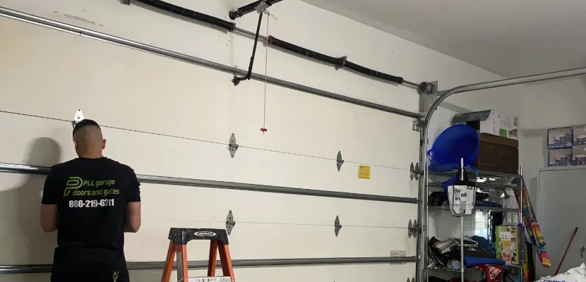 PLL technician repairing a residential garage door
