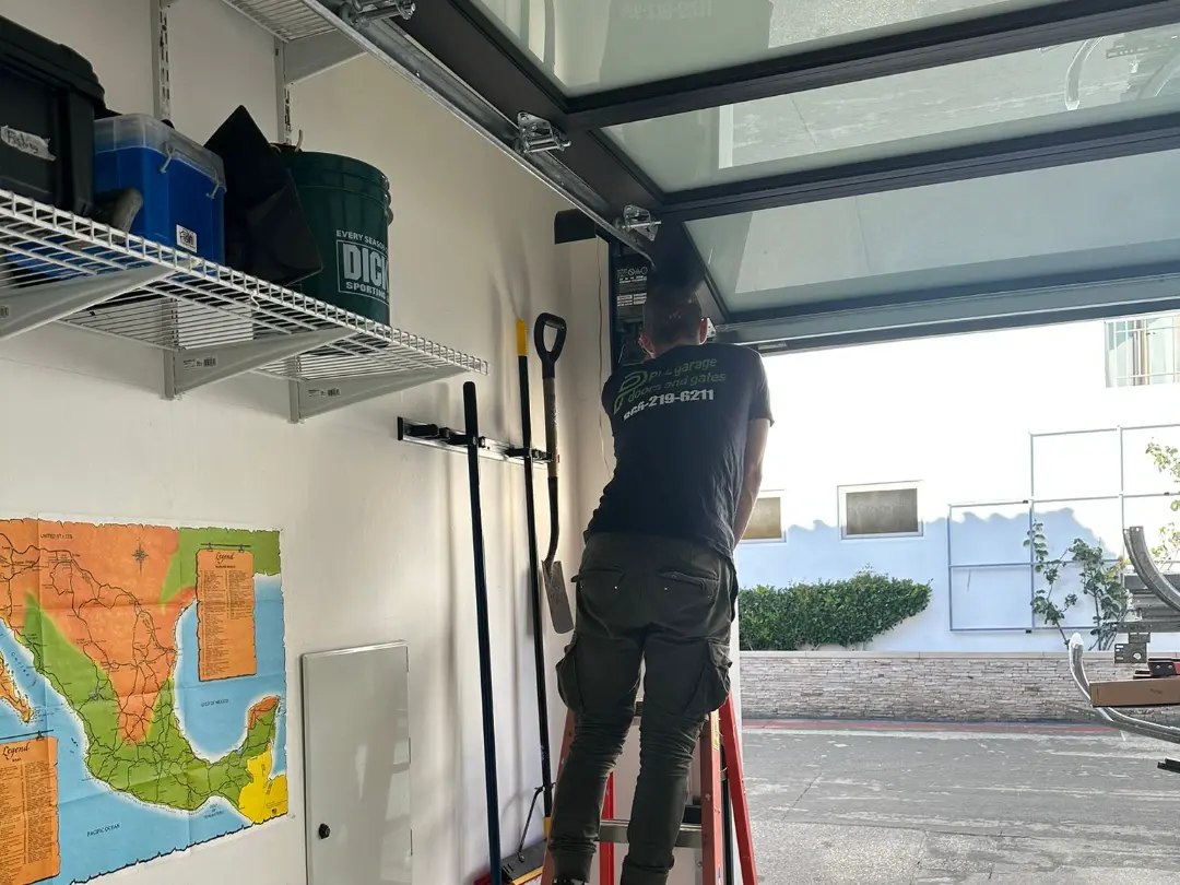 PLL technician servicing a glass panel garage door