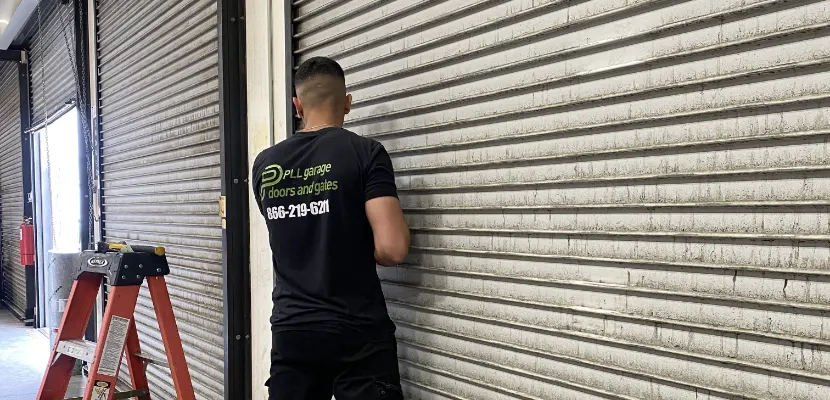 PLL technician servicing a roll-up door