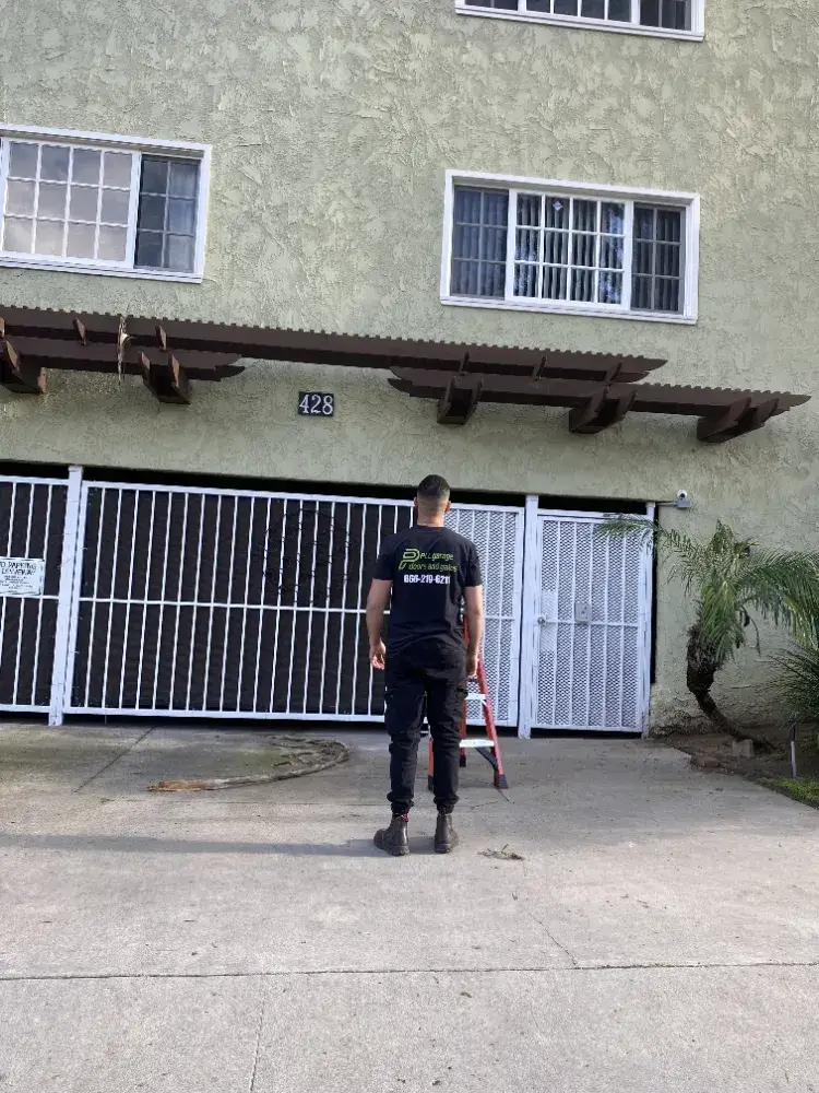 PLL technician at a steel driveway gate