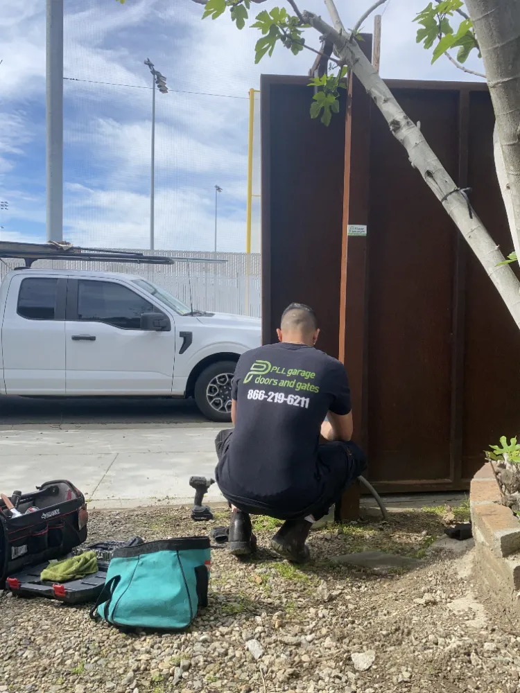 PLL technician working on a wooden gate